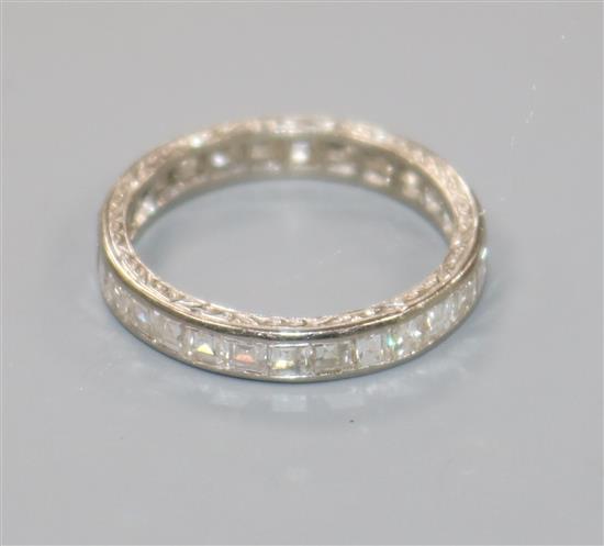 A white metal and square cut diamond full eternity ring, size I.